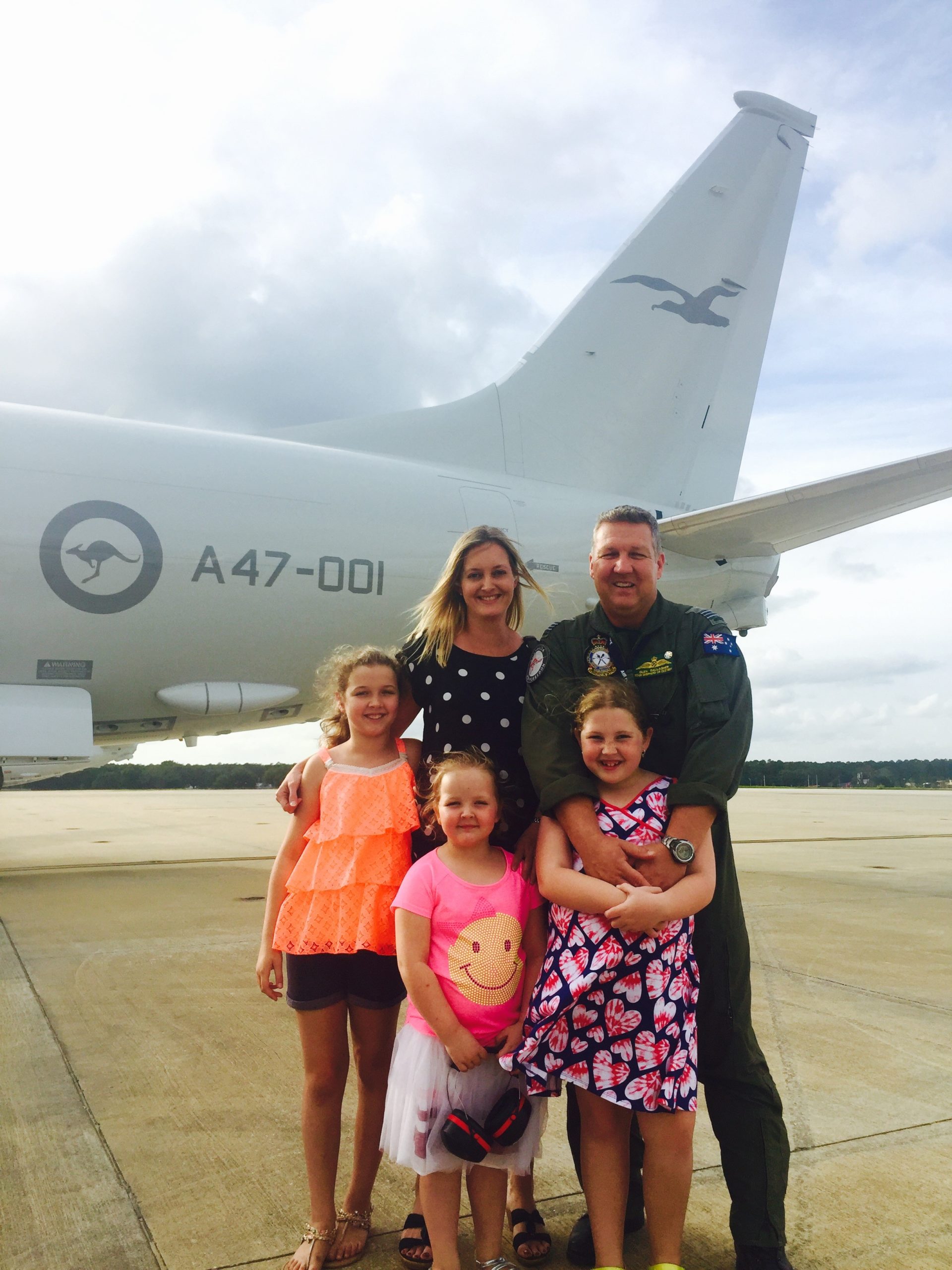 Glen Gallagher and family in front of a military aircraft