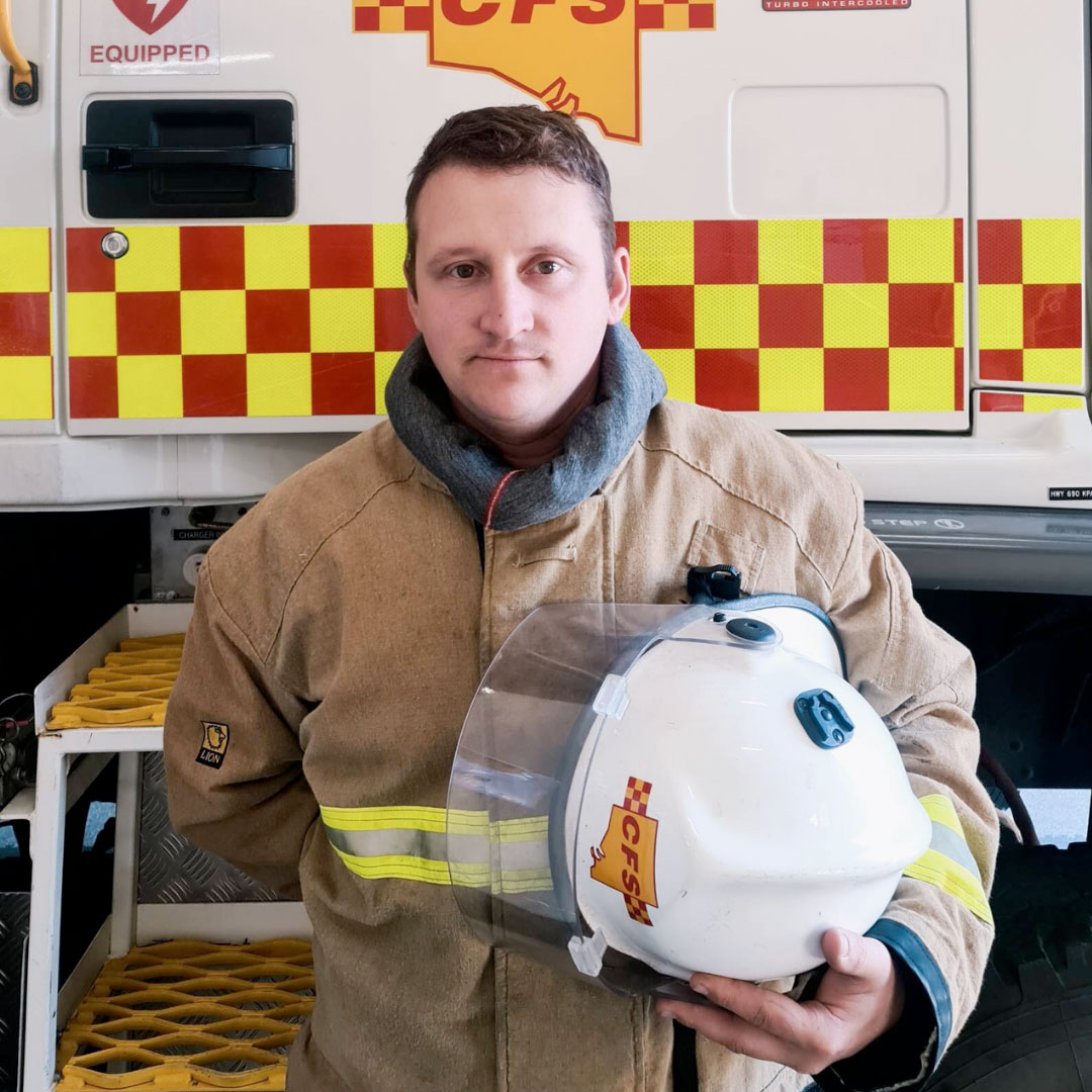 James Dunn in uniform in front of a CFS appliance
