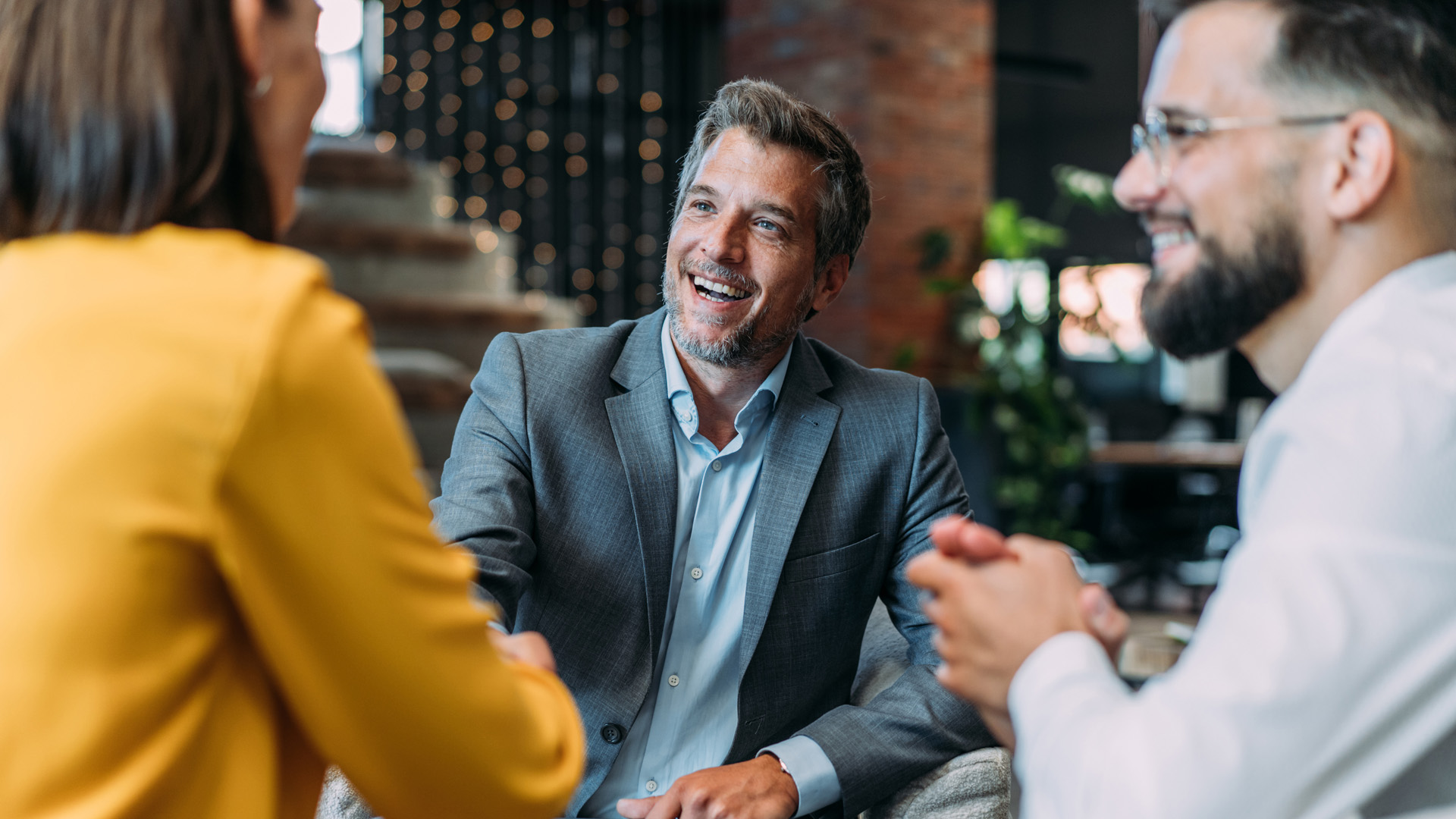 Entrepreneurs handshaking during a meeting with their colleagues in the office. Business persons shaking hands on a meeting.