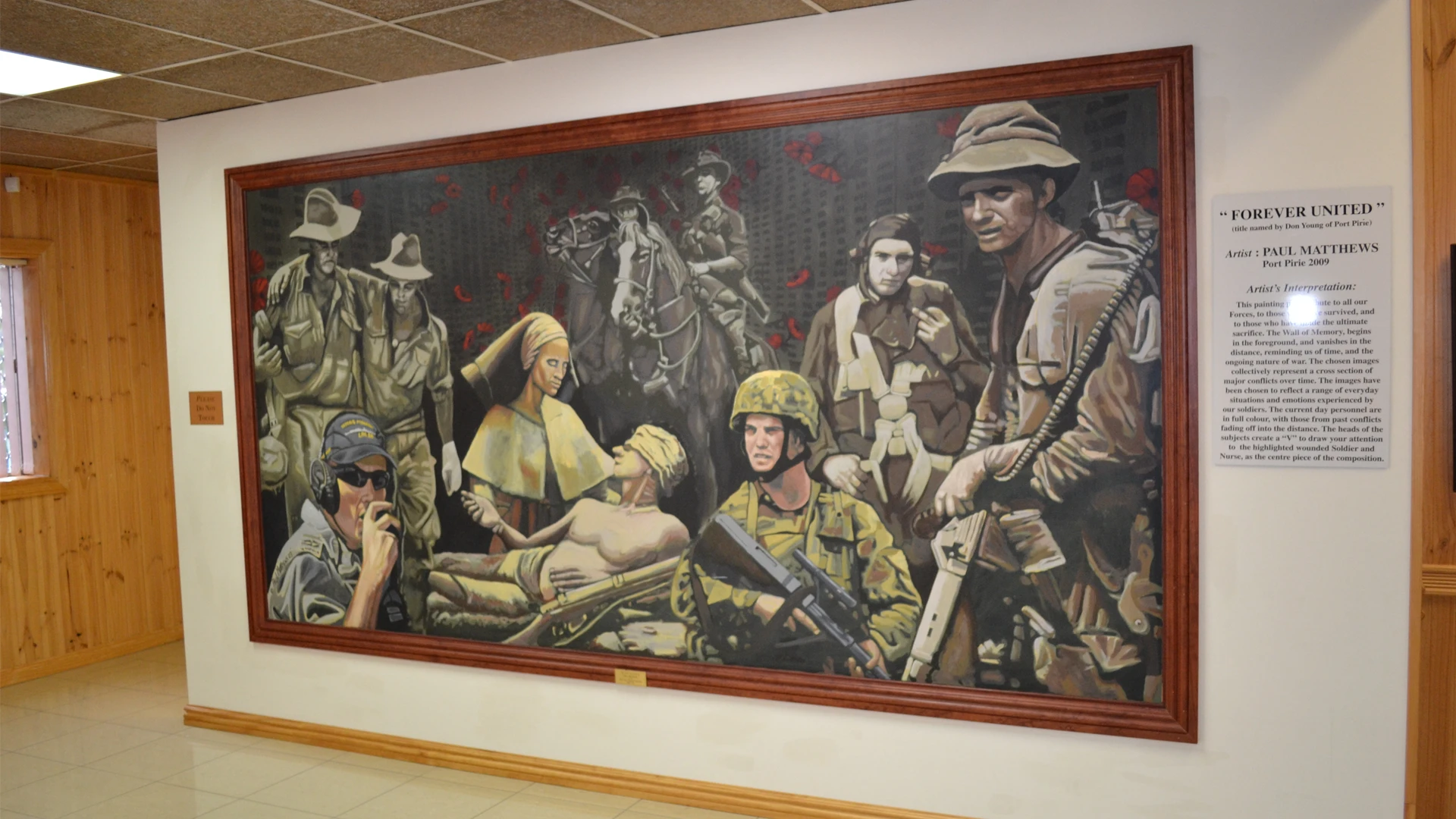 Large framed military-themed mural displayed on an indoor wall.