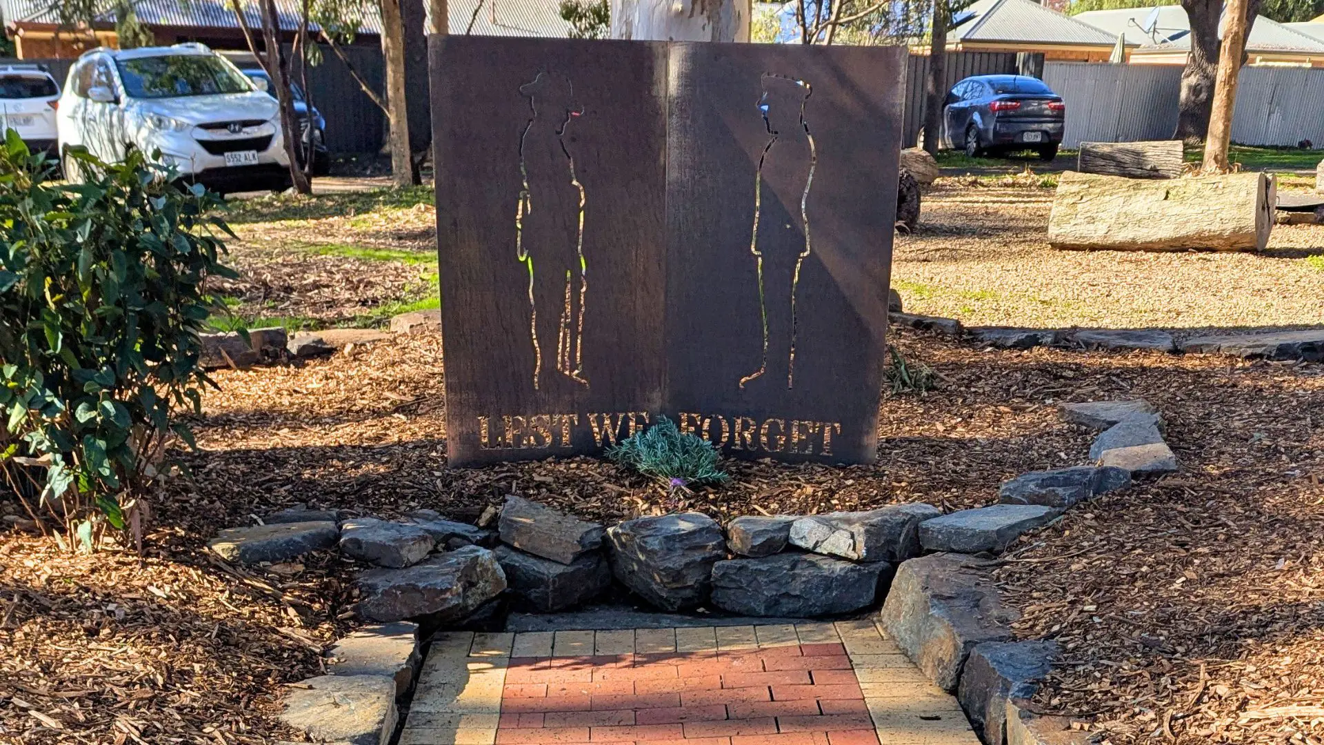 Memorial path at Mount Barker High School featuring commemorative bricks honouring former students who served in World War I and World War II, as well as service sculptures and the restoration of archival displays.