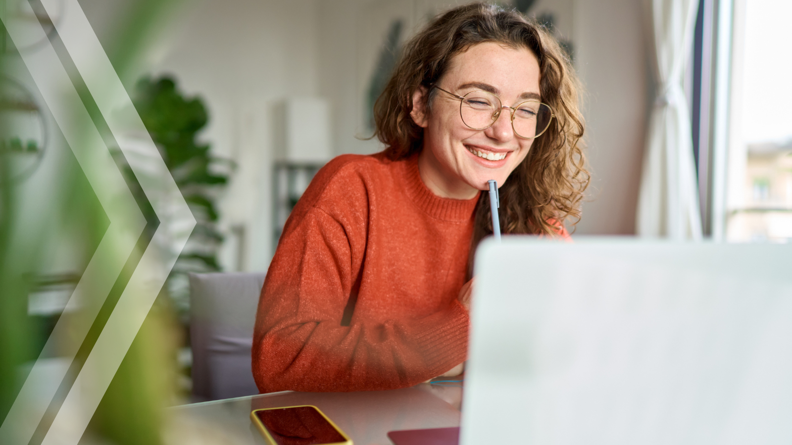 Girl sitting in front of a laptop in a home environment